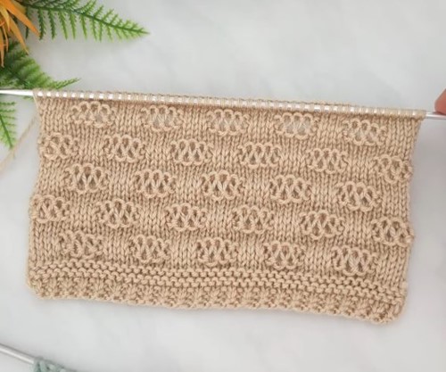 Lace-looking knitting pattern made with fine yarn in pastel colors